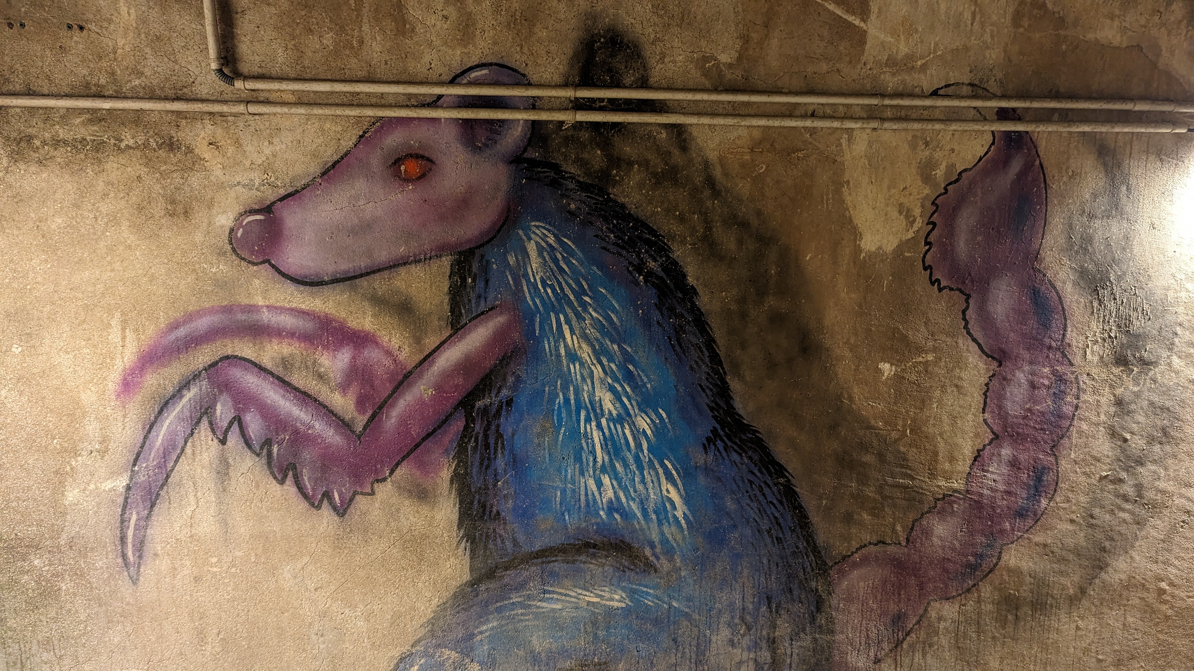 Street-art of a sewer rat inside the museum.