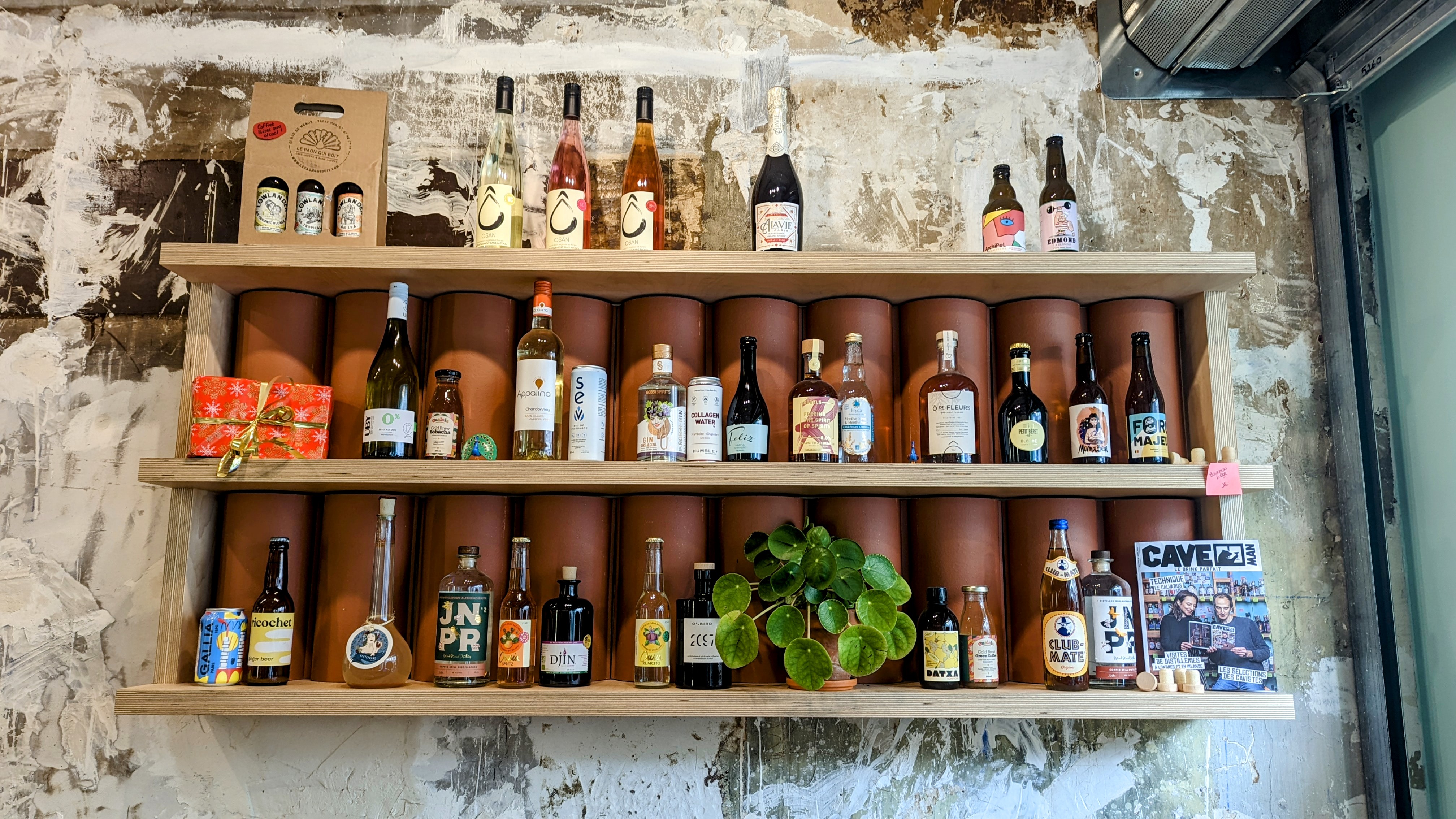 A shelf inside the store with alcohol-free wine, beer and soft drinks.