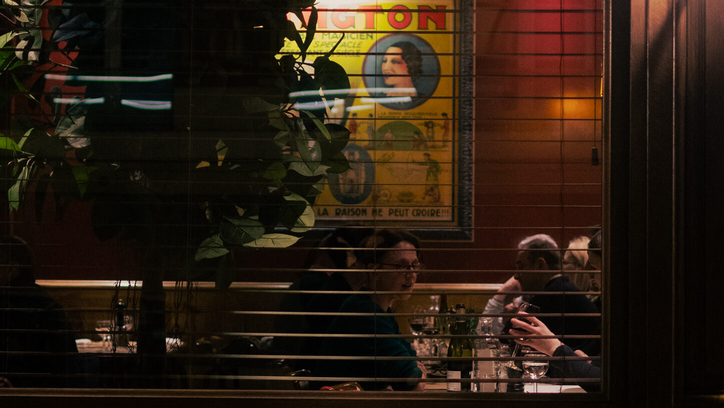 Patrons in a restaurant during Paris Fashion week.