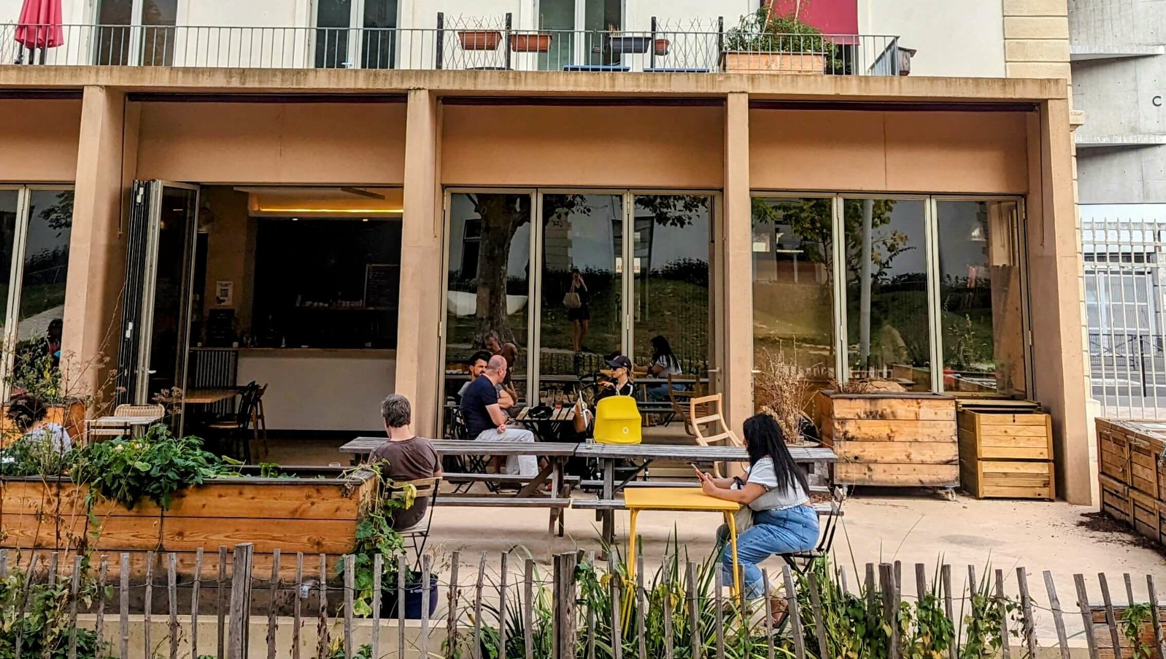 Customers are relaxing on the terrace of the café of La Maison du Zero Déchet in Paris, a venue that's all about zero waste.