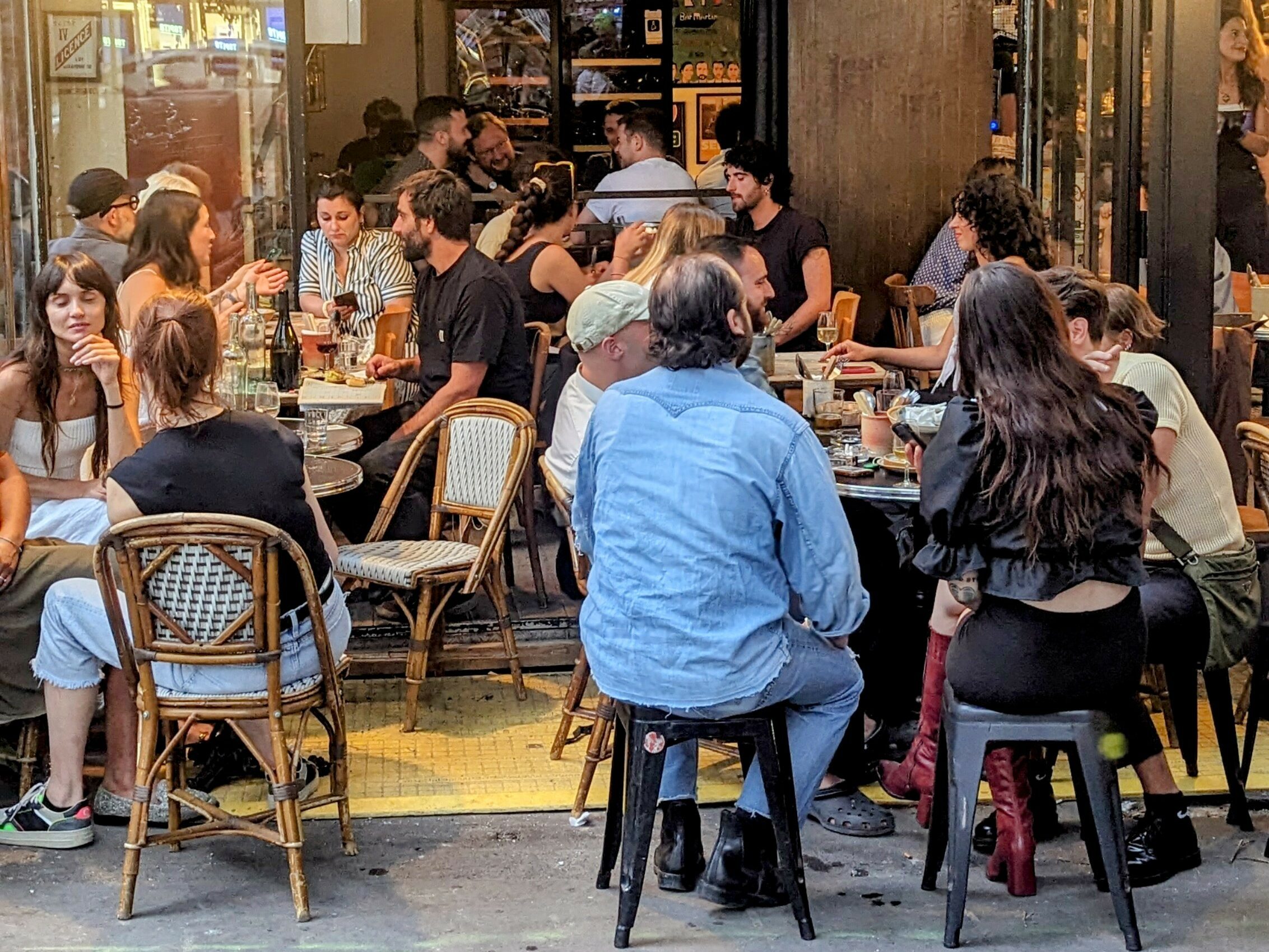 Parisians sharing wine and food on the terrace of restaurant Martin in the 11th arrondissement of Paris.