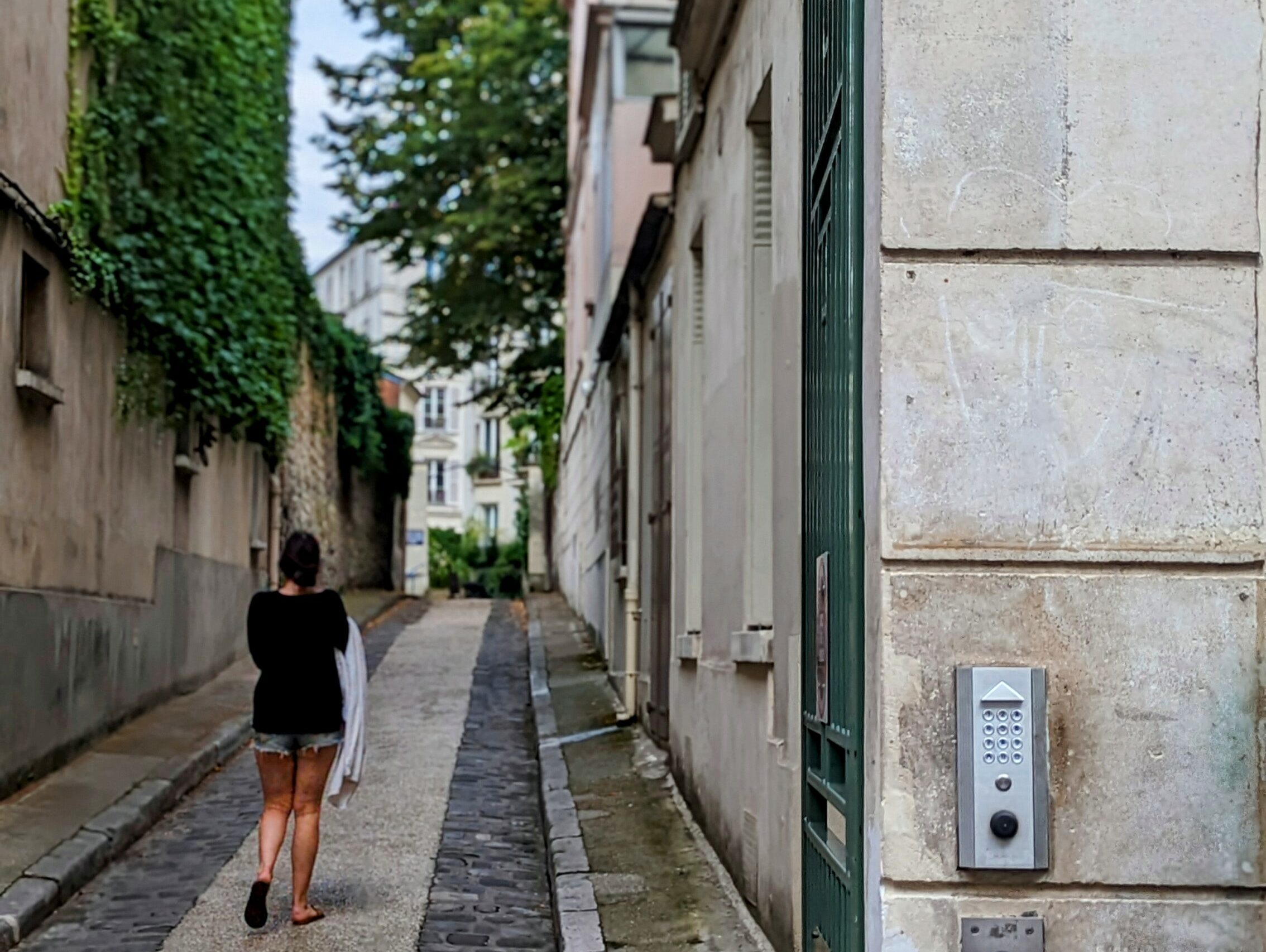 A woman staying in the former residence of James Joyce in the 5th arrondissement is entering her home.