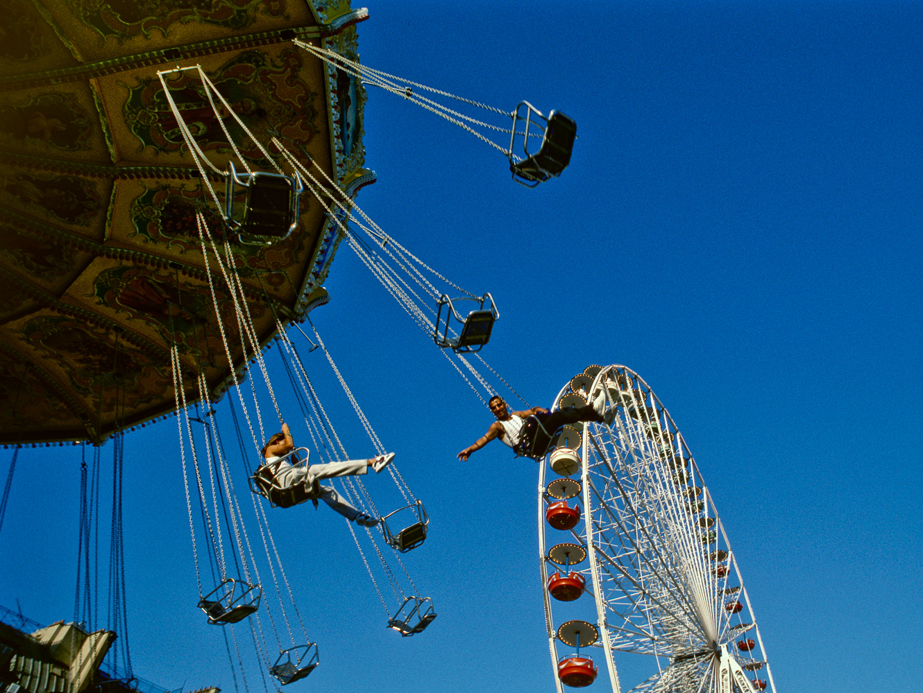 Parisians having fun on a merry-go-round on a hot summer day.