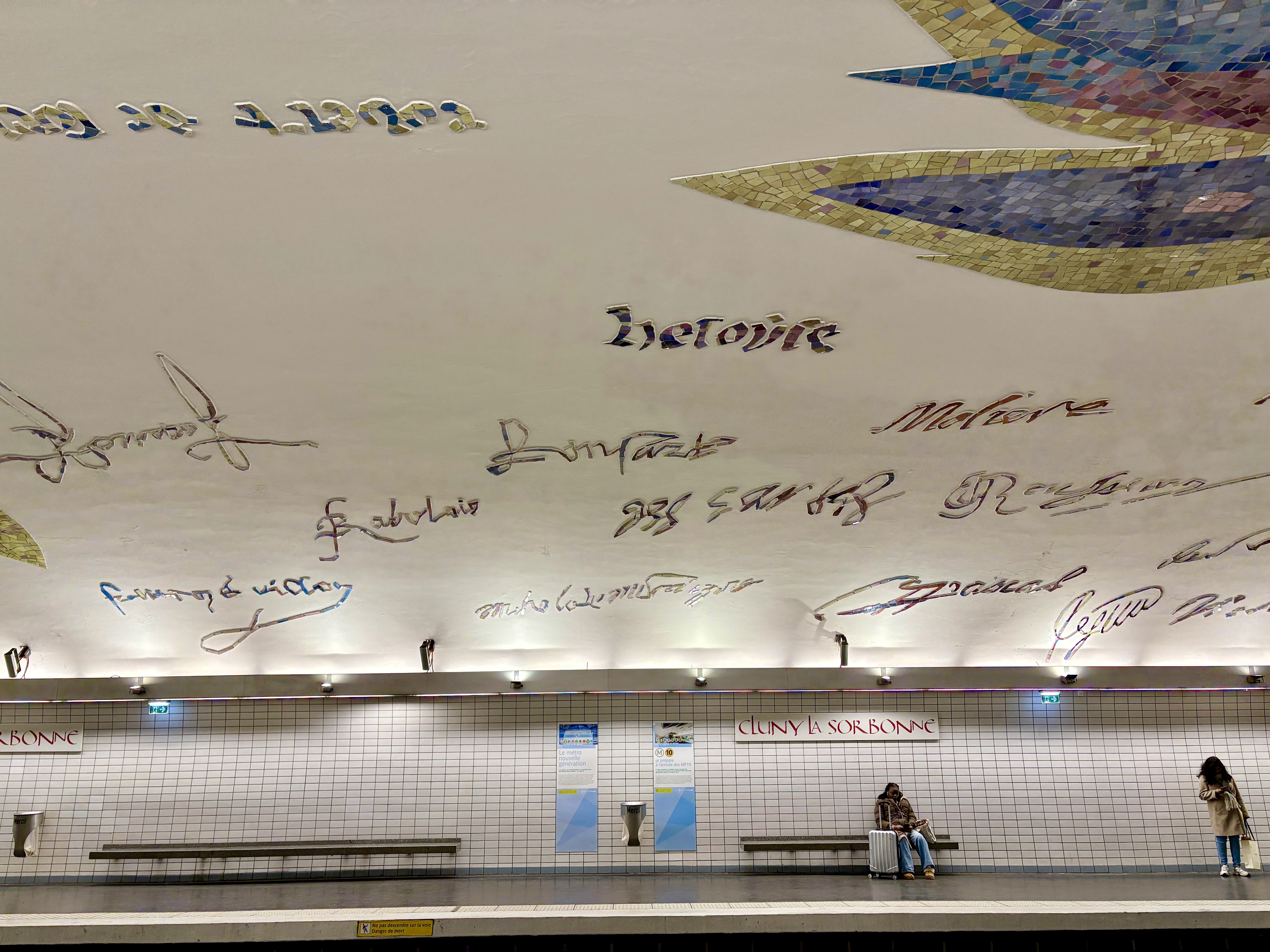 The Cluny - La Sorbonne metro station with the colorful signatures of famous Sorbonne alumni on the ceiling.