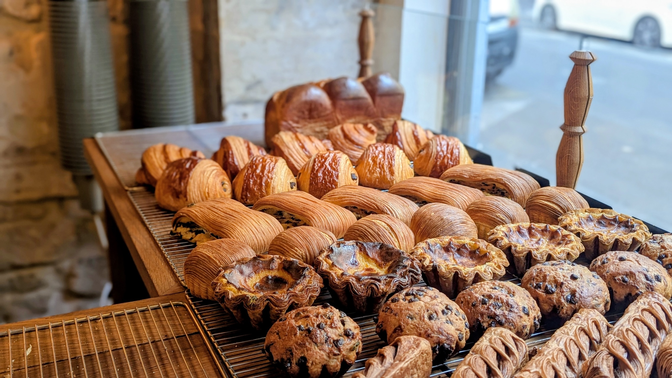 A display of freshly baked croissants and pastries in a Parisian bakery.